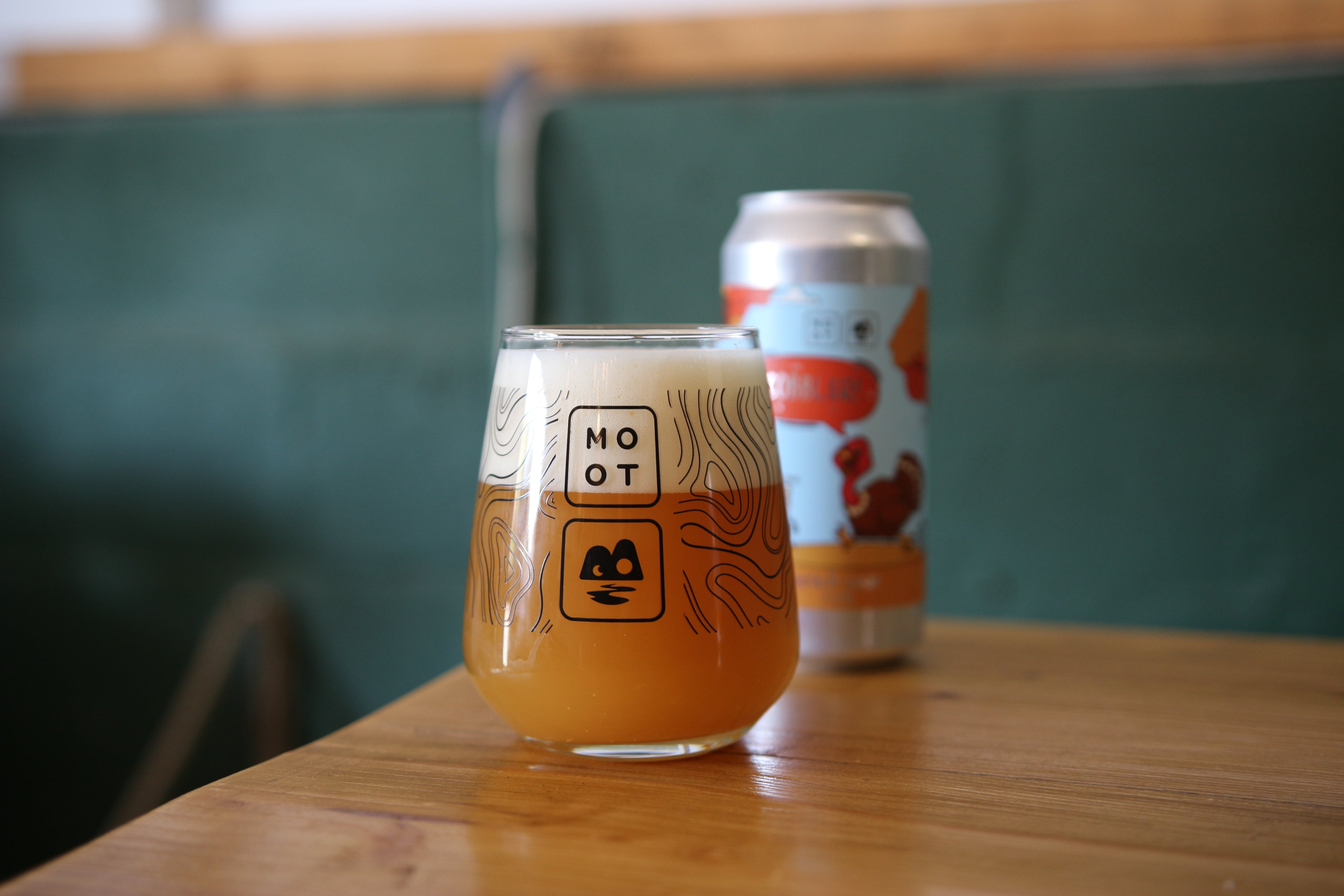 Peach pastry sour beer poured into glass with golden hue and foamy head