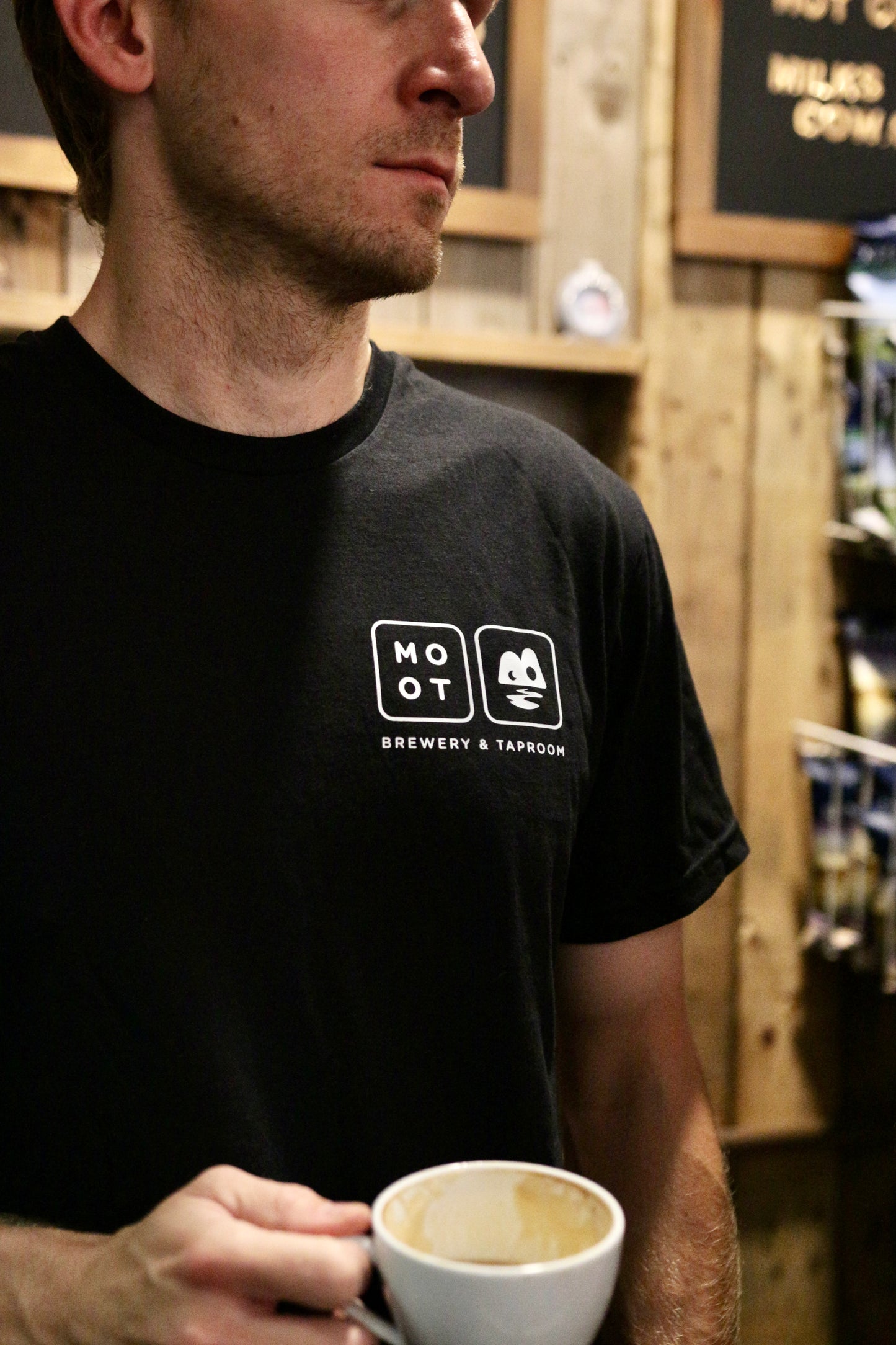 Person wearing Moot Brewery & Taproom logo tee at taproom