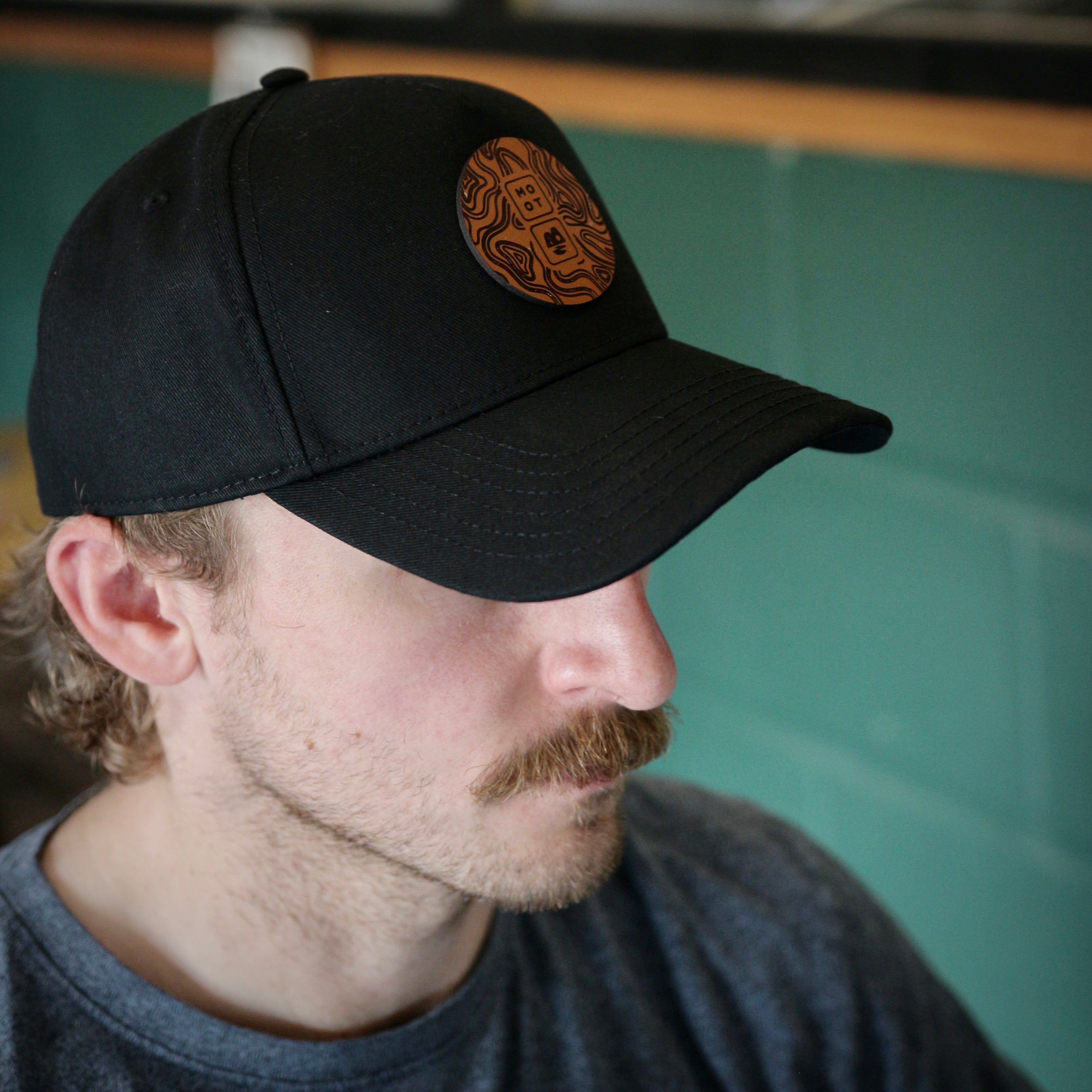Person wearing Moot Brewery Logo Snapback Cap at taproom