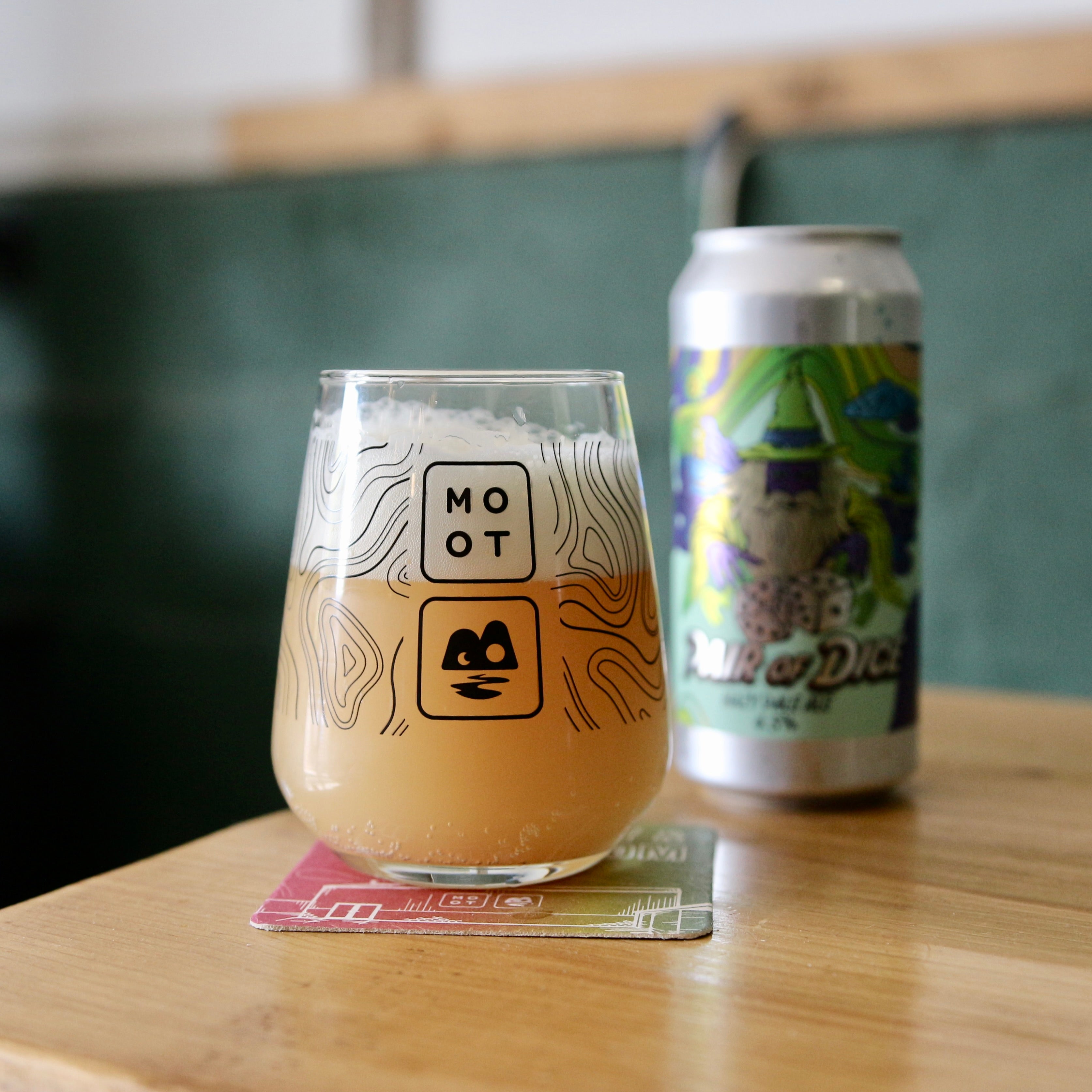 Golden pale ale poured into glass with white foam and bright citrus aroma