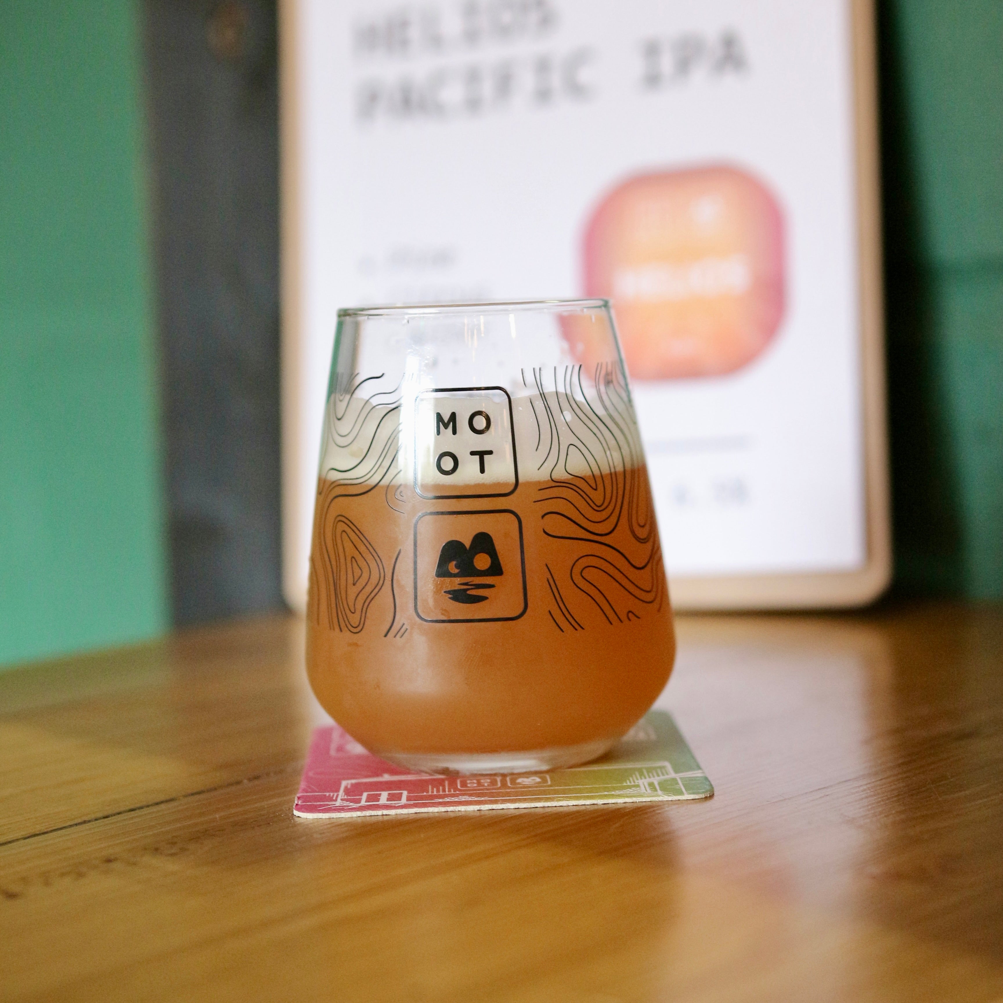 Golden IPA poured into glass with white foam and bright tropical aroma