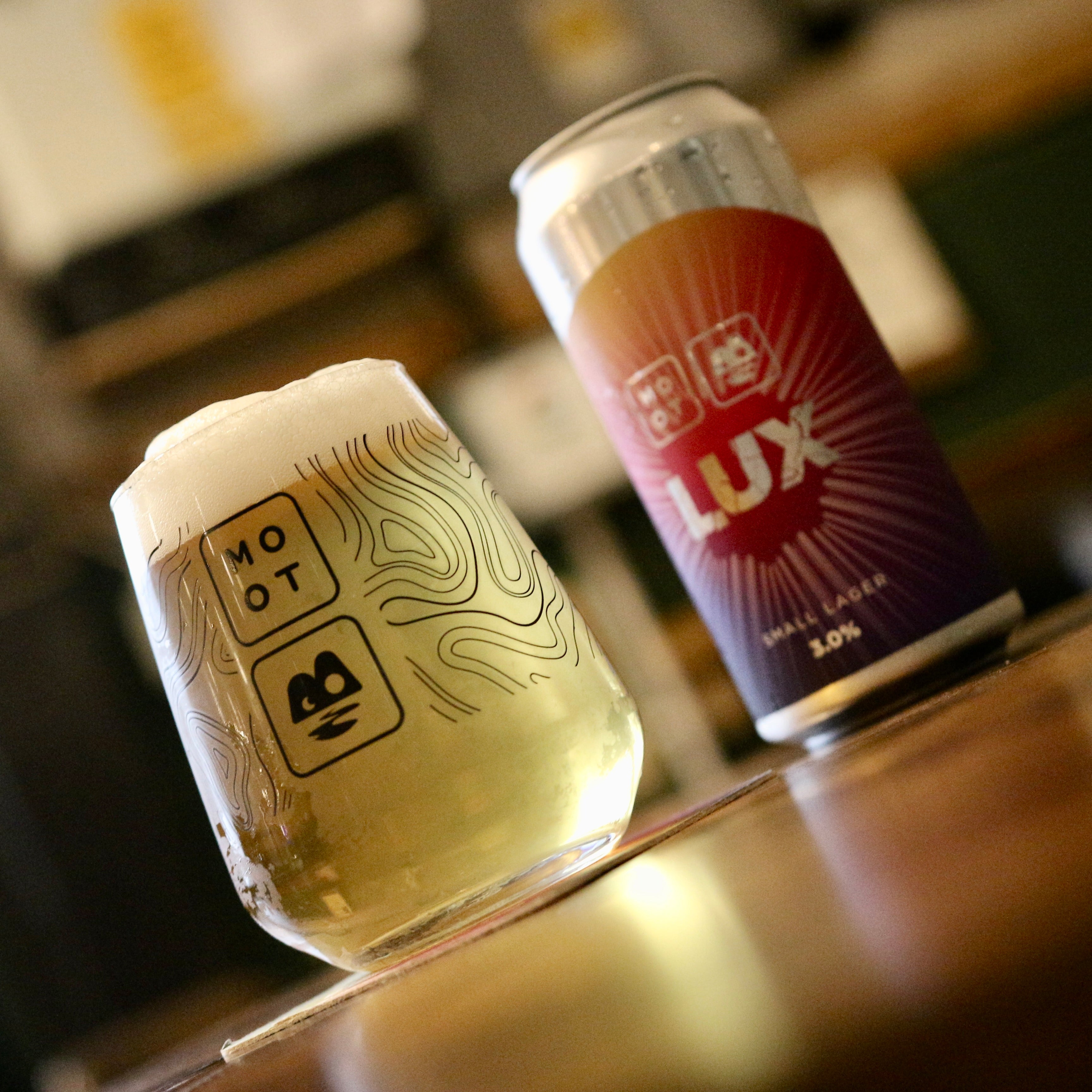 Clear golden pour of Lux Lager with white foam