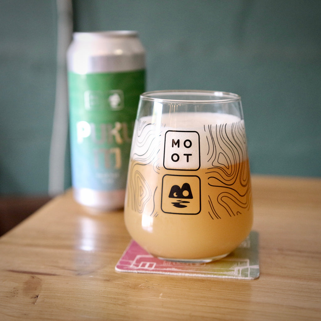 Golden hazy pale ale poured into glass with white foam and juicy aroma