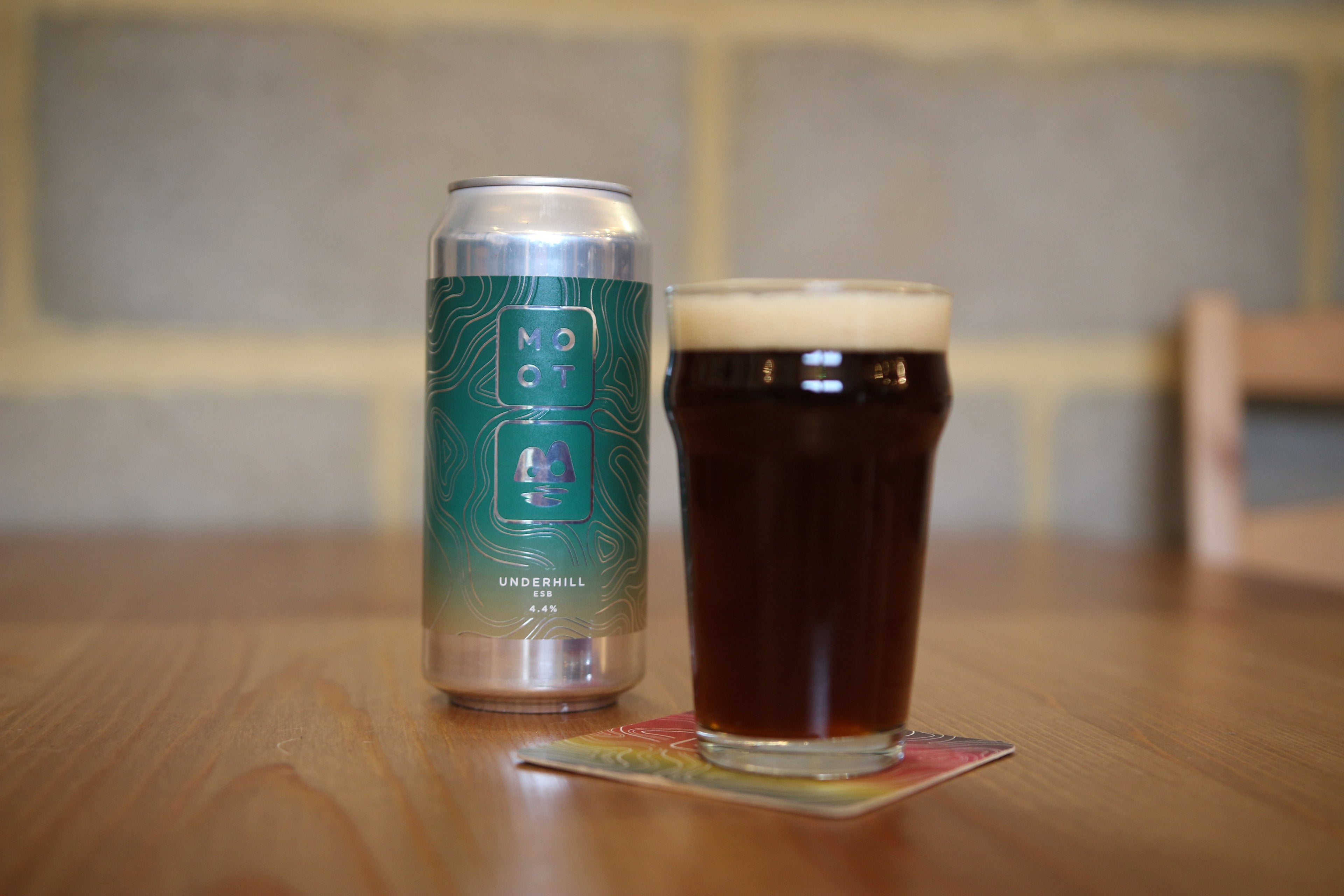 Amber-brown ESB beer poured into glass with creamy head and malt aroma