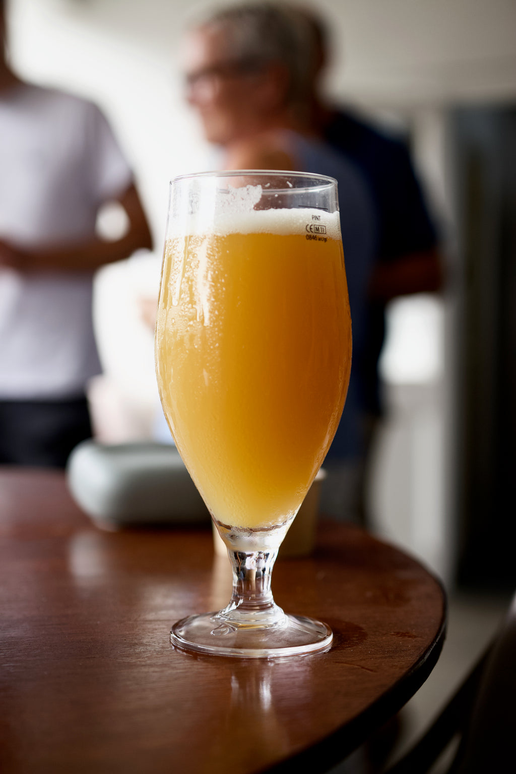 Golden Session IPA poured into glass with white foam and tropical hop aroma